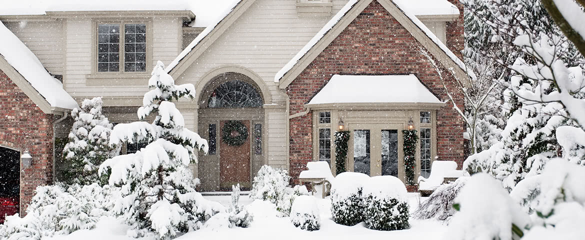 Residential home covered in a blanket of deep snow during the winter