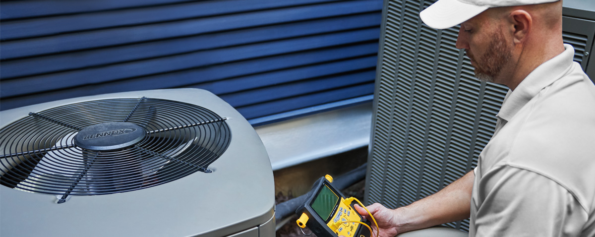 Dealer inspecting an AC capacitor