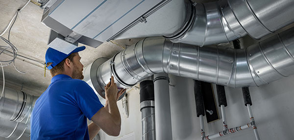 Dealers inspecting the air ducts of a house